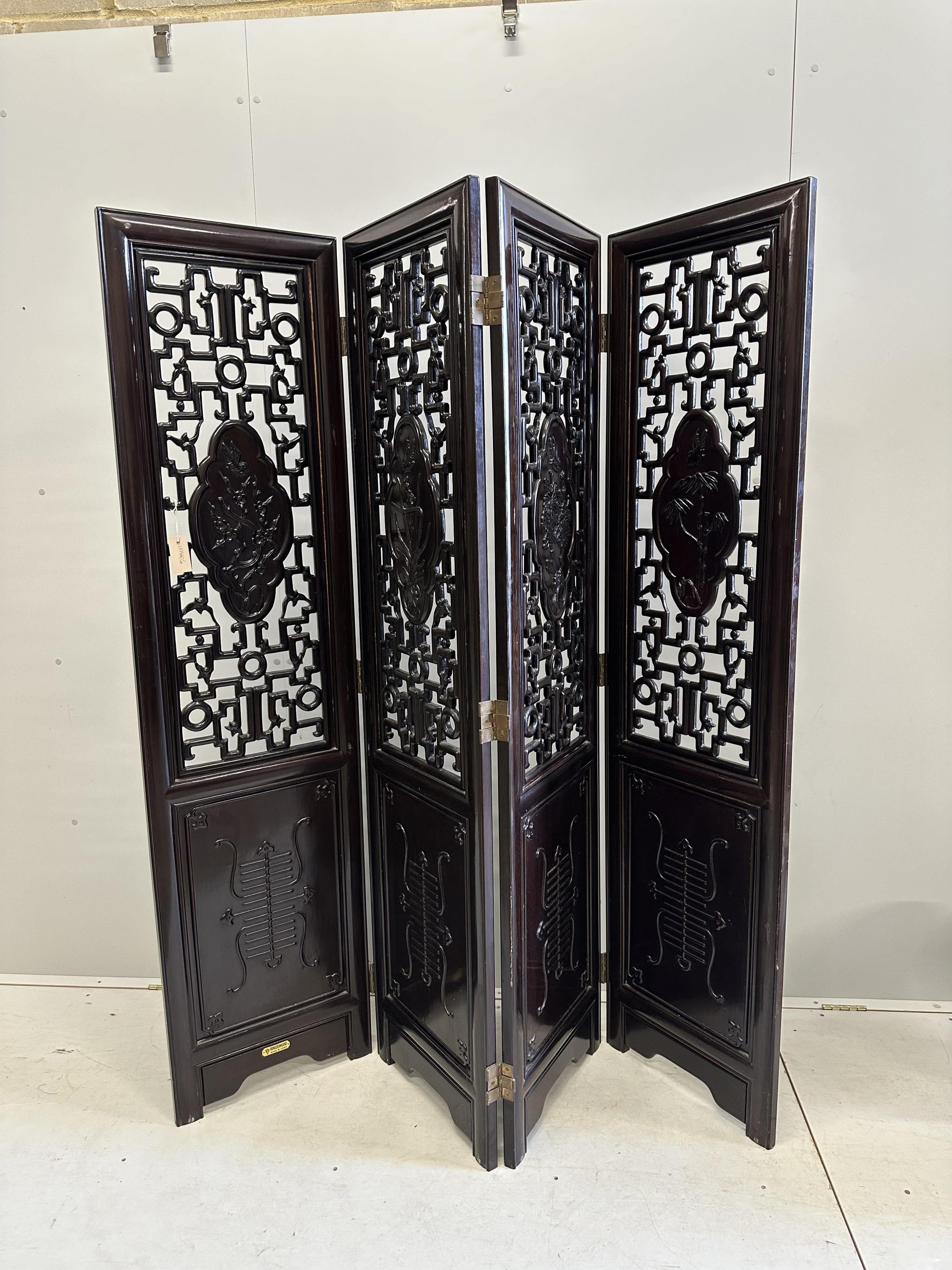 A Chinese carved hardwood four fold screen, each panel width 45cm, height 183cm. Condition - good